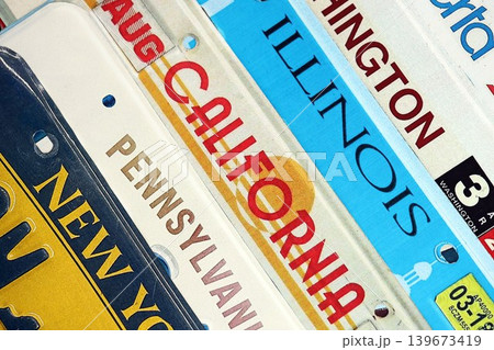 Old US car license plates with various state names. Concept of driving in United States Old US car license plates with various state names. Concept of driving in United States 139673419