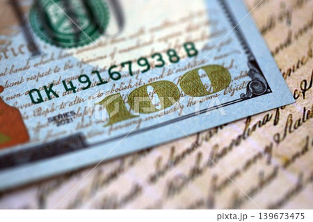 One hundred US dollar bills and United States Constitution fragment. Concept of lawsuit and bribery One hundred US dollar bills and United States Constitution fragment. Concept of lawsuit and bribery 139673475