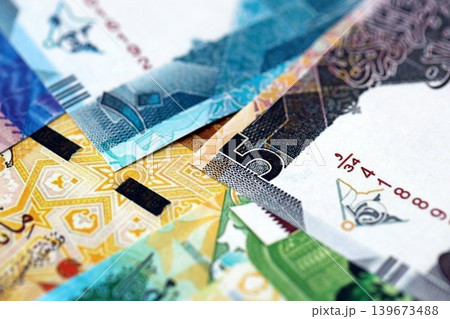 Qatari riyal money bills banknotes lies in big pile on table. Finances and business in Qatar Qatari riyal money bills banknotes lies in big pile on table. Finances and business in Qatar 139673488