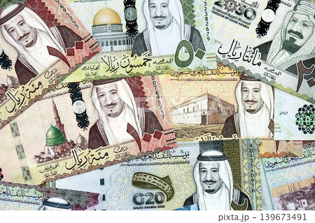 Saudi Arabia riyal money bills banknotes lies in big pile on table. Business in Saudi Arabia 139673491