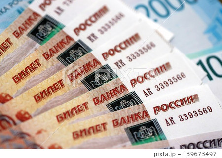 Russian ruble money bills banknotes lies in big pile on table. Concept of finances and business Russian ruble money bills banknotes lies in big pile on table. Concept of finances and business 139673497