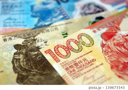 Big pile of Hong Kong dollars money bills banknotes. Lots of money of Chinese Hong Kong HKD cash 139673543