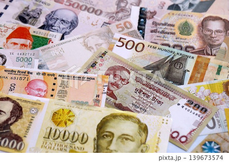 Various currencies money bills banknotes in yellow and orange color. Many cash bills Various currencies money bills banknotes in yellow and orange color. Many cash bills 139673574