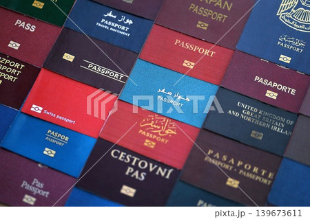 Big amount of passports of various different countries. Covers of expired passports close up Big amount of passports of various different countries. Covers of expired passports close up 139673611