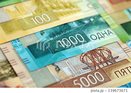 Russian ruble paper banknotes pile on table. Russia RUB currency money bills in big amount Russian ruble paper banknotes pile on table. Russia RUB currency money bills in big amount 139673671