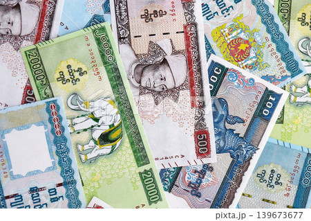 Myanmar kyat paper banknotes pile on table. Myanmar MMK currency money bills in big amount Myanmar kyat paper banknotes pile on table. Myanmar MMK currency money bills in big amount 139673677