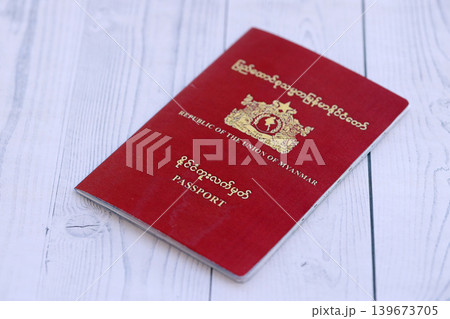 Myanmar passport on table close up. Official identification document book for citizens of Myanmar Myanmar passport on table close up. Official identification document book for citizens of Myanmar 139673705