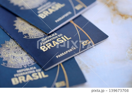 Three brazilian passports on table. Official identification document books for citizens of Brazil Three brazilian passports on table. Official identification document books for citizens of Brazil 139673708