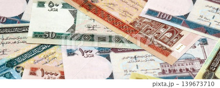 Afghan afghani paper banknotes pile on table. Afghanistan AFN currency money bills in big amount Afghan afghani paper banknotes pile on table. Afghanistan AFN currency money bills in big amount 139673710
