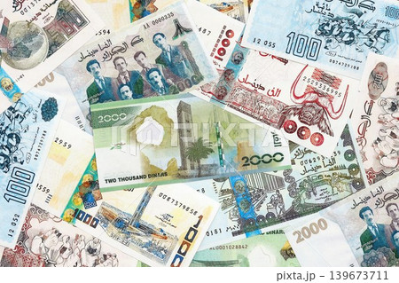 Algerian dinar paper banknotes pile on table. Algeria DZD currency money bills in big amount Algerian dinar paper banknotes pile on table. Algeria DZD currency money bills in big amount 139673711