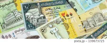Yemeni rial paper banknotes pile on table. Yemen YER currency money bills in big amount Yemeni rial paper banknotes pile on table. Yemen YER currency money bills in big amount 139673725
