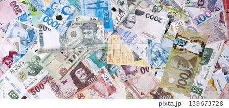 Different colorful banknotes from many various currencies of the world. Big stack of money bills 139673728