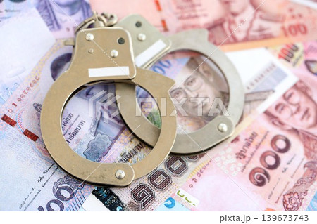 Thai baht currency money bills and handcuffs. The concept of criminal 139673743