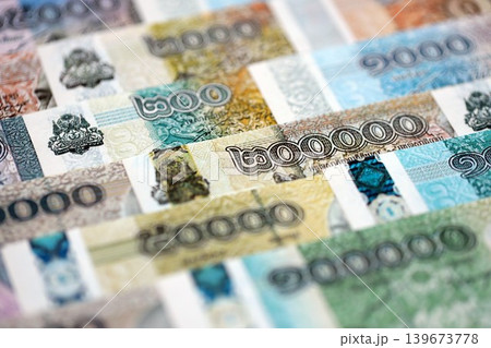 Cambodian riel money bills pile on table. Cambodia banknotes of KHR currency close up 139673778