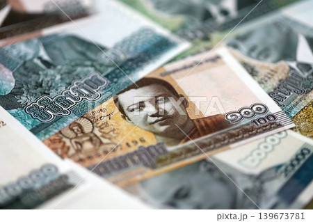 Cambodian riel money bills pile on table. Cambodia banknotes of KHR currency close up Cambodian riel money bills pile on table. Cambodia banknotes of KHR currency close up 139673781