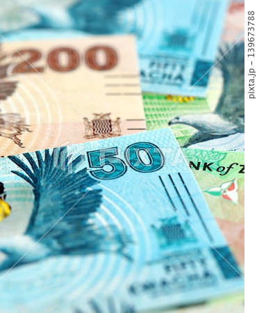 Zambian kwacha money bills pile on table. Zambia banknotes of ZMW currency close up 139673788