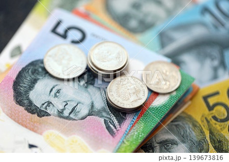 Australian dollar money bills and cent coins pile. Australia coins on banknotes of AUD currency 139673816