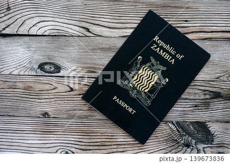 Zambian passport on table close up. Official identification document book for citizens of Zambia Zambian passport on table close up. Official identification document book for citizens of Zambia 139673836