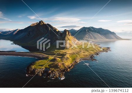 Aerial View of Eystrahorn mountain by coastal peninsula during golden hour in East Iceland 139674112