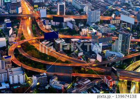 Cityscape of modern Bangkok city with illuminated skyscraper building and rush traffic on expressway Cityscape of modern Bangkok city with illuminated skyscraper building and rush traffic on expressway 139674138