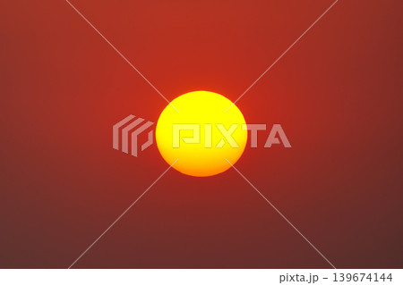 Golden yellow sun glowing on clear warm sky 139674144