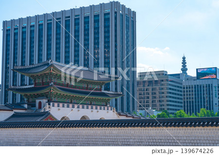 Seoul, South Korea - May. 14, 2026 : Historical Gyeongbokgung Gwanghwamun Gate with modern city buildings under a blue sky in Seoul, South Korea 139674226