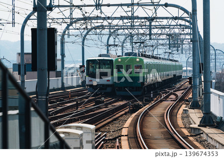 Electric railway train with metal structure and tracks arrival to station at Kyoto Electric railway train with metal structure and tracks arrival to station at Kyoto 139674353