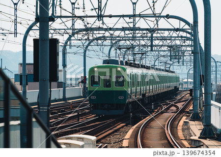 Electric railway train with metal structure and tracks arrival to station at Kyoto 139674354