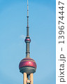 Closeup of Oriental Pearl TV Tower with pink spheres and antenna against blue sky Closeup of Oriental Pearl TV Tower with pink spheres and antenna against blue sky 139674447