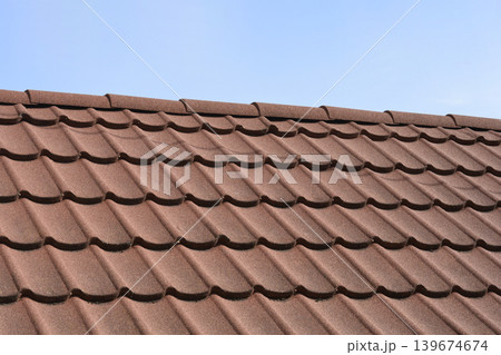 Close up of brown stone coated metal roof tiles 139674674