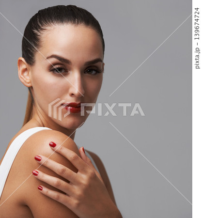 Makeup, woman in portrait for cosmetics and manicure in studio, nail polish and lashes with skin and beauty on grey background. Red lipstick, nails and glamour, mascara for confidence and elegance 139674724