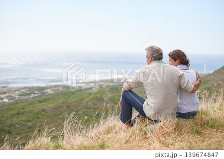 Old couple, hug and sitting on a mountain with love in marriage, retirement or holiday mockup space. Summer, vacation and man and woman embrace with support, care or trust with view of sea or ocean Old couple, hug and sitting on a mountain with love in marriage, retirement or holiday mockup space. Summer, vacation and man and woman embrace with support, care or trust with view of sea or ocean 139674847
