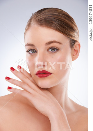 Woman, portrait and makeup in studio with red lipstick for cosmetics, beauty and aesthetic with nail polish. Model, person and confidence with skincare, glowing face and wellness on white background Woman, portrait and makeup in studio with red lipstick for cosmetics, beauty and aesthetic with nail polish. Model, person and confidence with skincare, glowing face and wellness on white background 139674851