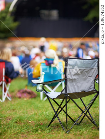Outdoor, concert and people with camping chair, festival and blur background with audience. Crowd, outside and seat with party, social event and environment with musical celebration, break and grass Outdoor, concert and people with camping chair, festival and blur background with audience. Crowd, outside and seat with party, social event and environment with musical celebration, break and grass 139674852
