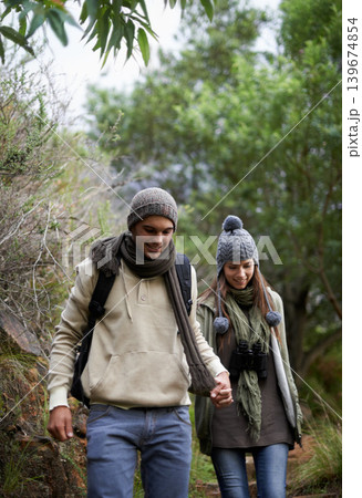 Couple, happy and hiking in forest or holding hands with travel, adventure and nature for wellness or fitness. Man, woman and trekking in woods for cardio, exercise or workout with view or backpack Couple, happy and hiking in forest or holding hands with travel, adventure and nature for wellness or fitness. Man, woman and trekking in woods for cardio, exercise or workout with view or backpack 139674854