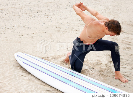 Surfer, man is stretching and beach sand with surfboard for ocean waves and start fitness, adventure and travel. Nature, vacation and surfing in Hawaii, summer holiday on an island and extreme sports Surfer, man is stretching and beach sand with surfboard for ocean waves and start fitness, adventure and travel. Nature, vacation and surfing in Hawaii, summer holiday on an island and extreme sports 139674856