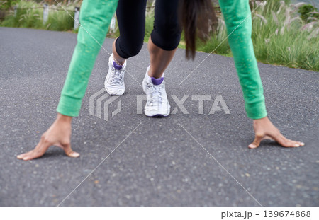 Woman, hands and feet, start running for fitness with race or marathon, athlete preparing and training outdoor. Runner is ready, exercise for cardio and speed with challenge, sports and health Woman, hands and feet, start running for fitness with race or marathon, athlete preparing and training outdoor. Runner is ready, exercise for cardio and speed with challenge, sports and health 139674868