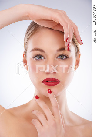 Woman, portrait and makeup in studio with manicure for cosmetics, beauty and aesthetic with red lipstick. Model, person or confidence with skincare, glowing face and skin wellness on white background Woman, portrait and makeup in studio with manicure for cosmetics, beauty and aesthetic with red lipstick. Model, person or confidence with skincare, glowing face and skin wellness on white background 139674897