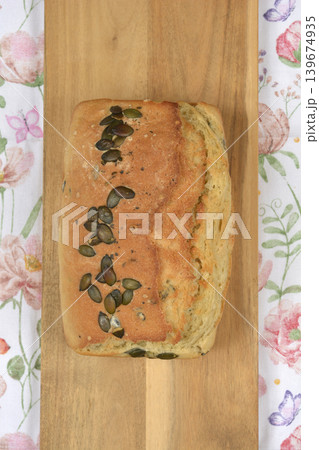 Homemade bread with pumpkin seeds on a wooden board Homemade bread with pumpkin seeds on a wooden board 139674935