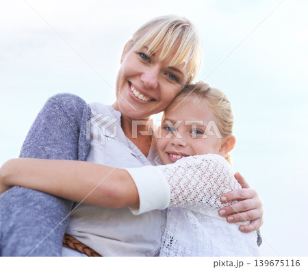 Mother, daughter and portrait with hug outdoor for bonding, holiday or vacation memories with blue sky. Family, woman and girl child with embrace for relationship, love and care in nature with smile Mother, daughter and portrait with hug outdoor for bonding, holiday or vacation memories with blue sky. Family, woman and girl child with embrace for relationship, love and care in nature with smile 139675116