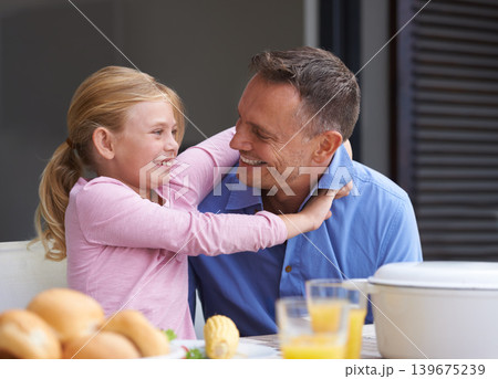 Family, father and daughter hugging for lunch at dining room table in home together for health, diet or nutrition. Food, smile or happy with man parent and young girl child in apartment for lunch Family, father and daughter hugging for lunch at dining room table in home together for health, diet or nutrition. Food, smile or happy with man parent and young girl child in apartment for lunch 139675239