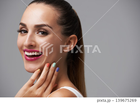 Happy woman, portrait and manicure with pink lipstick for beauty, rainbow nail polish and cosmetics on grey background. Cosmetology, lips and color nails with makeup, confidence and glamour in studio 139675269