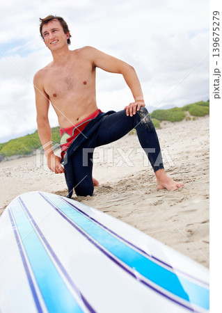 Beach, happy man or ready to start surfing with surfboard on vacation or adventure for fitness or travel. Smile, waiting or athlete at sea on holiday in Hawaii or ocean for wellness or extreme sports 139675279