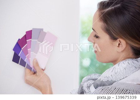 Home renovation, painting and woman with sample for color choice, comparison or checking hue in a house. Interior design, paint swatch and lady person at a wall for planning, decoration or remodeling 139675339