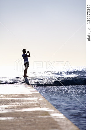 Silhouette, waves and ocean, man and photography with phone on holiday and travel in Miami, mockup space and summer. Adventure, content creator or influencer with picture for blog and sea view Silhouette, waves and ocean, man and photography with phone on holiday and travel in Miami, mockup space and summer. Adventure, content creator or influencer with picture for blog and sea view 139675349