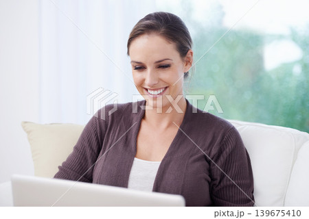Happy, woman or laptop for remote work on sofa to update blog post, social media or reading digital research. Freelancer, computer or download movie subscription, online shopping or elearning at home 139675410