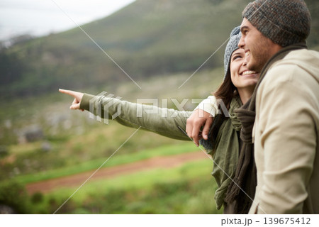 Travel, hiking and pointing with couple in mountains together for love, dating or sightseeing. Smile, environment or view with happy young man and woman in nature for adventure, holiday or vacation 139675412