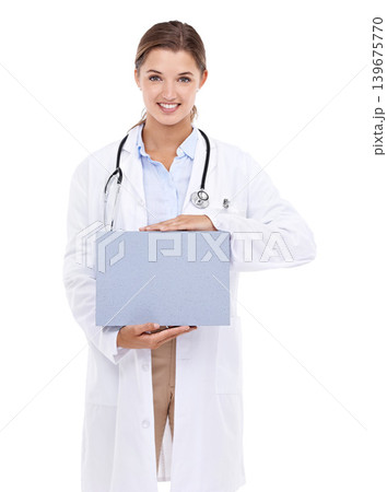 Sign, board and happy portrait of doctor in white background, studio and mock up space. Medical, information and woman with poster, presentation and paper for news in healthcare, hospital or clinic 139675770