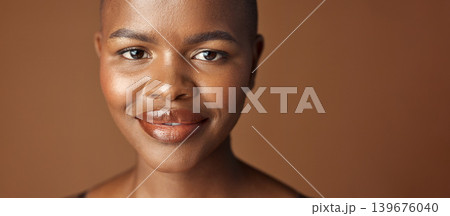 Face, beauty and smile with happy black woman in studio isolated on brown background for wellness. Portrait, skincare and aesthetic for foundation cosmetics or dermatology with a natural bald person Face, beauty and smile with happy black woman in studio isolated on brown background for wellness. Portrait, skincare and aesthetic for foundation cosmetics or dermatology with a natural bald person 139676040