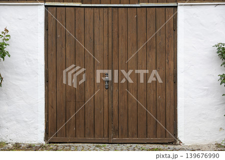 Rustic Double Wooden Door Between White Plaster Walls Architectural Background Rustic Double Wooden Door Between White Plaster Walls Architectural Background 139676990